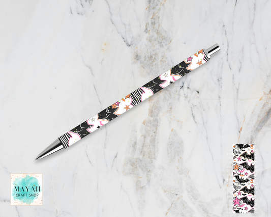 A retractable ballpoint pen with a black barrel decorated with a pink, white, and gold floral pattern, displayed diagonally on a white marble background. A small inset image in the bottom-right shows a close-up of the pattern.