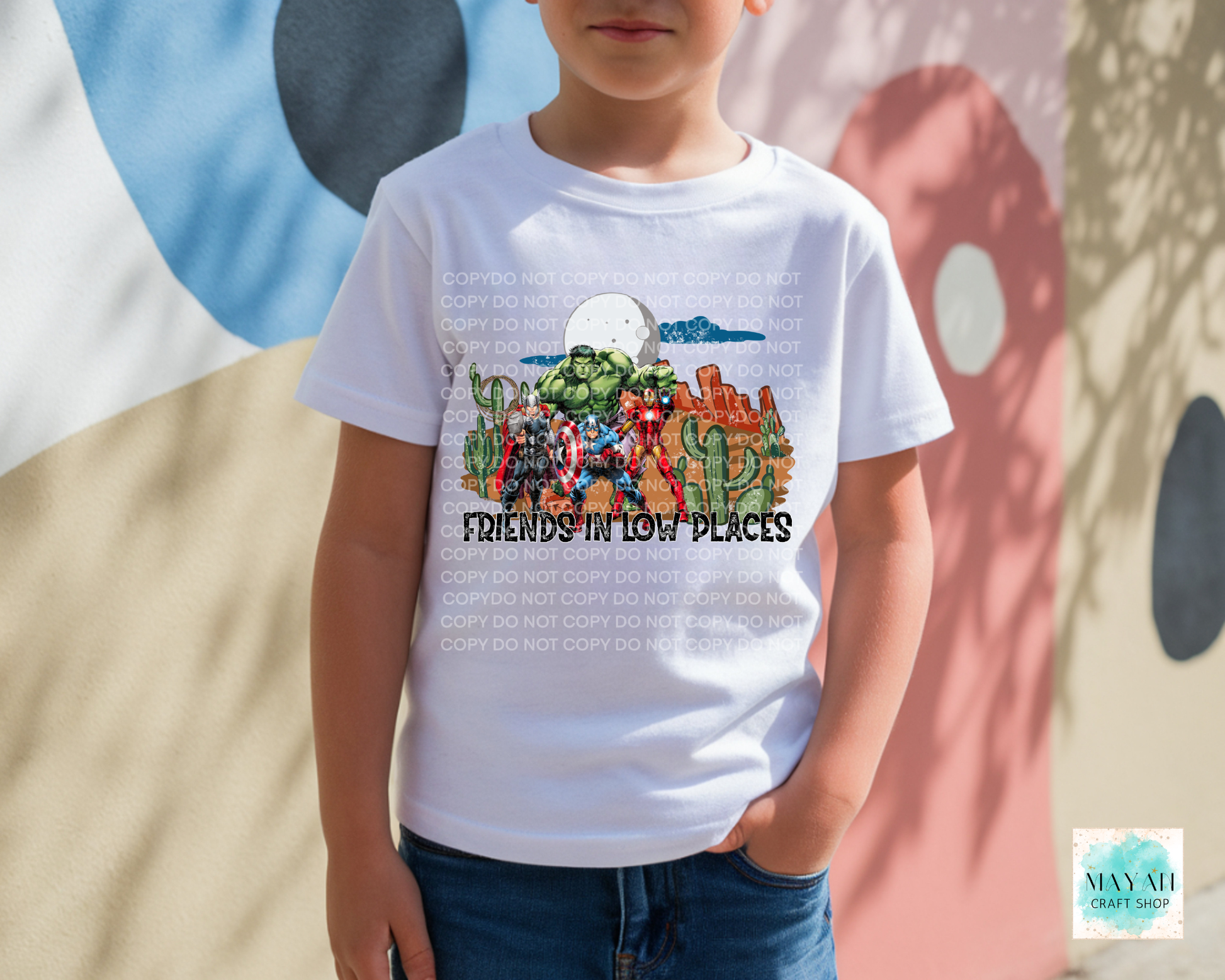 Child wearing a white t-shirt with colorful graphic design and text, standing against a multicolored abstract background.