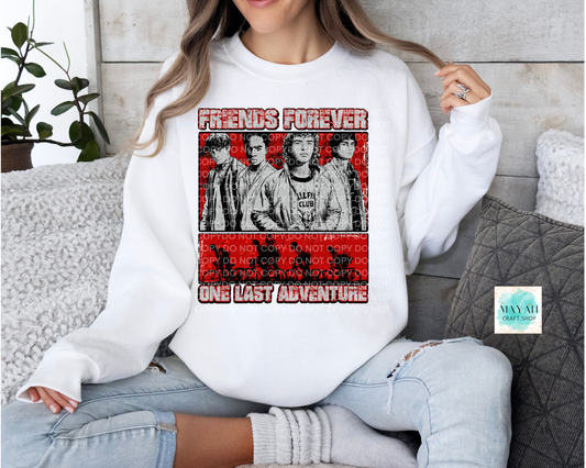 Person wearing a white sweatshirt with a graphic design and text, sitting on a couch.