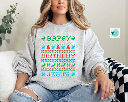 Person wearing a gray sweatshirt with 'Happy Birthday Jesus' text and Christmas-themed graphics.