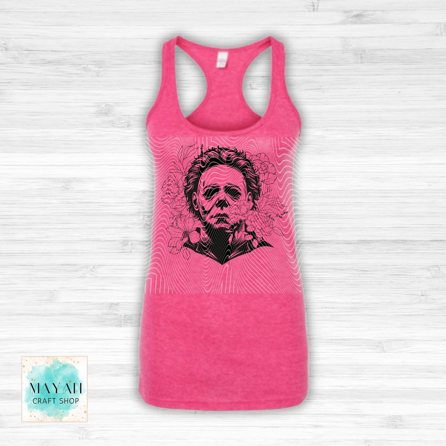Pink tank top with a graphic design on a white wooden background