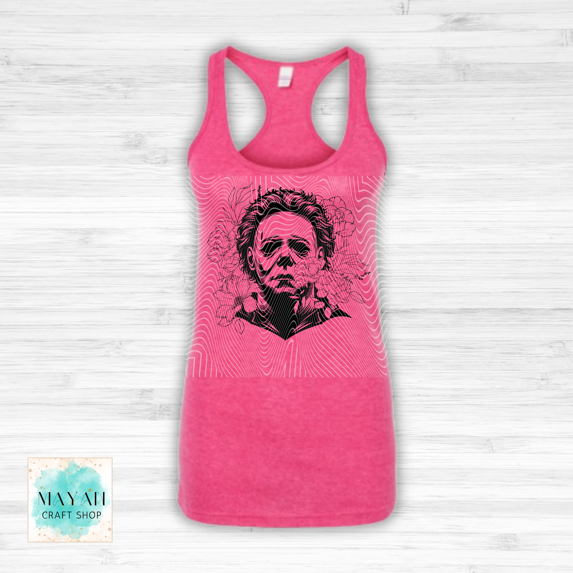 Pink tank top with a graphic design on a white wooden background