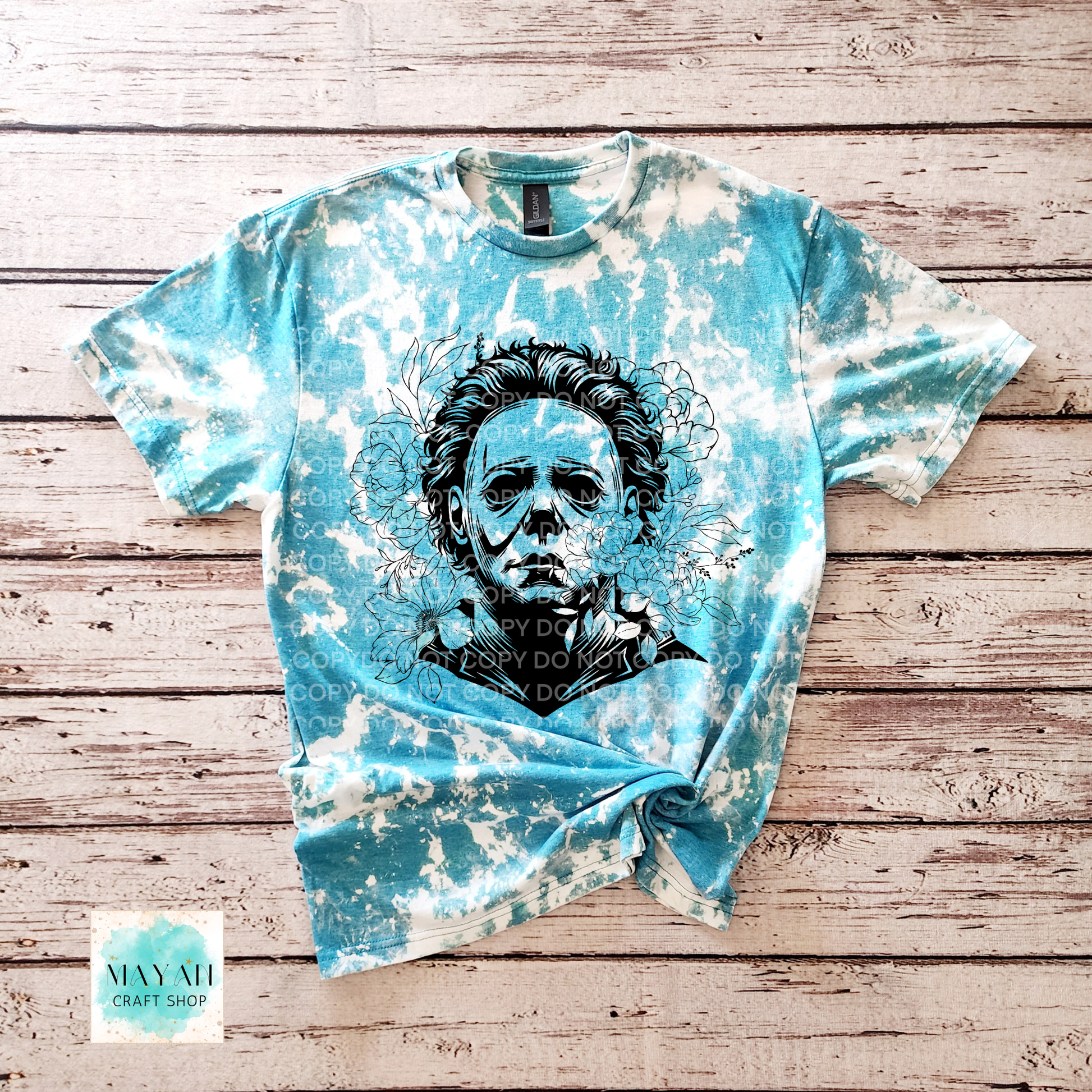 Bleached t-shirt with a graphic design on a wooden surface.