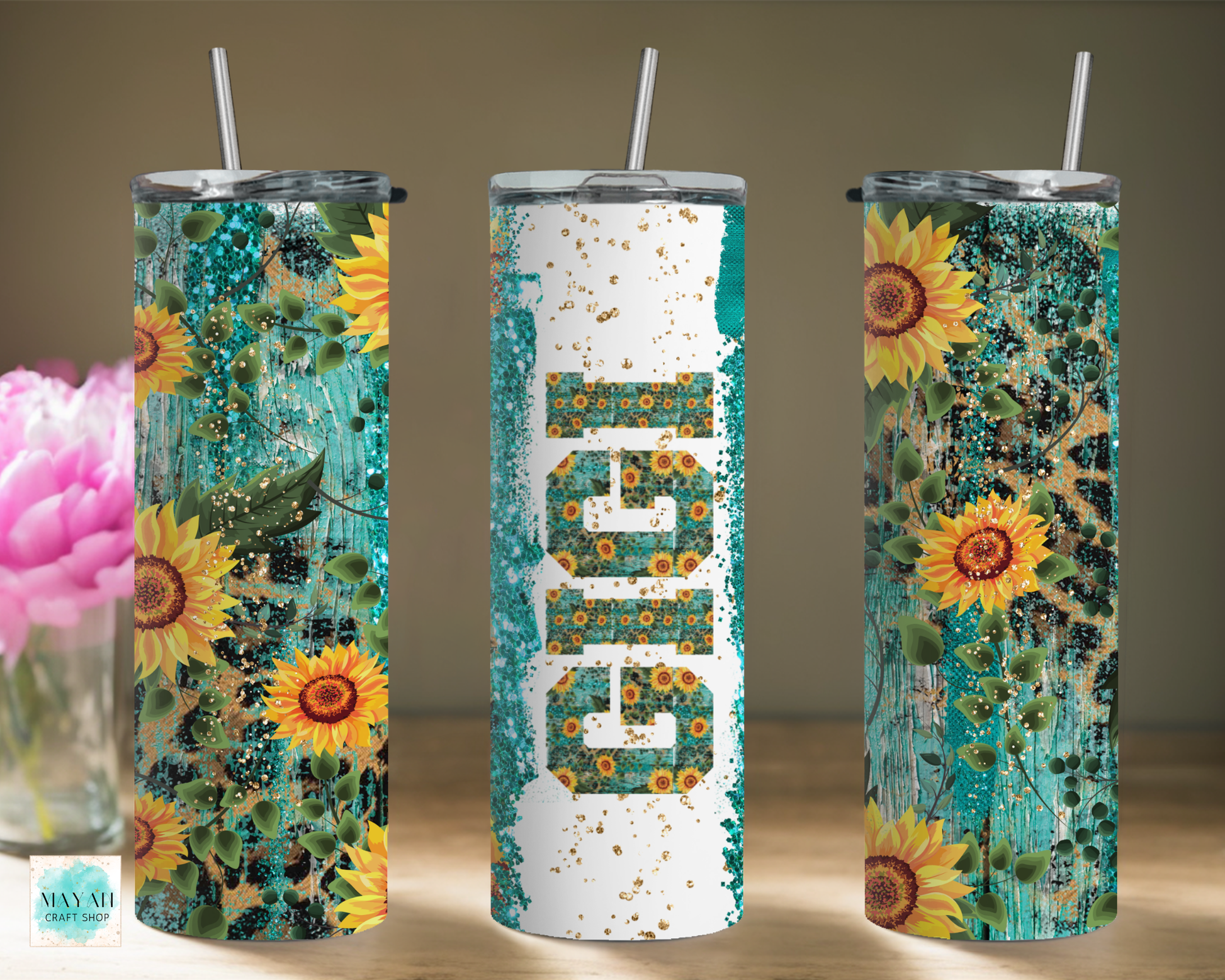 Three sunflower-themed tumblers with floral designs on a neutral background