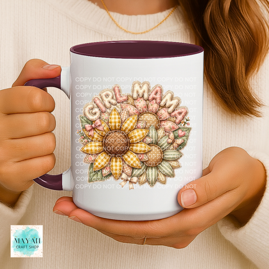 Person holding a mug with floral design and 'Girl Mama' text