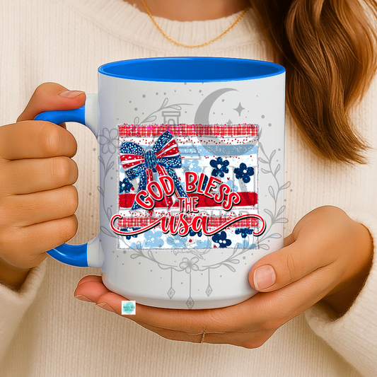 Person holding a mug with 'God Bless the USA' design