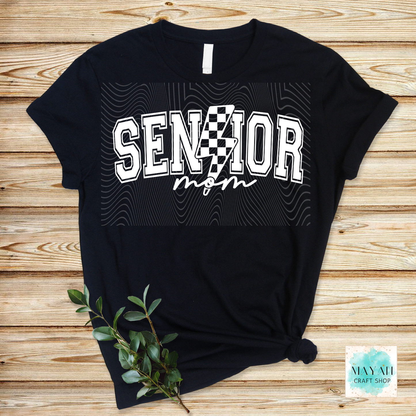 Black t-shirt with 'Senior Mom' text on a wooden surface