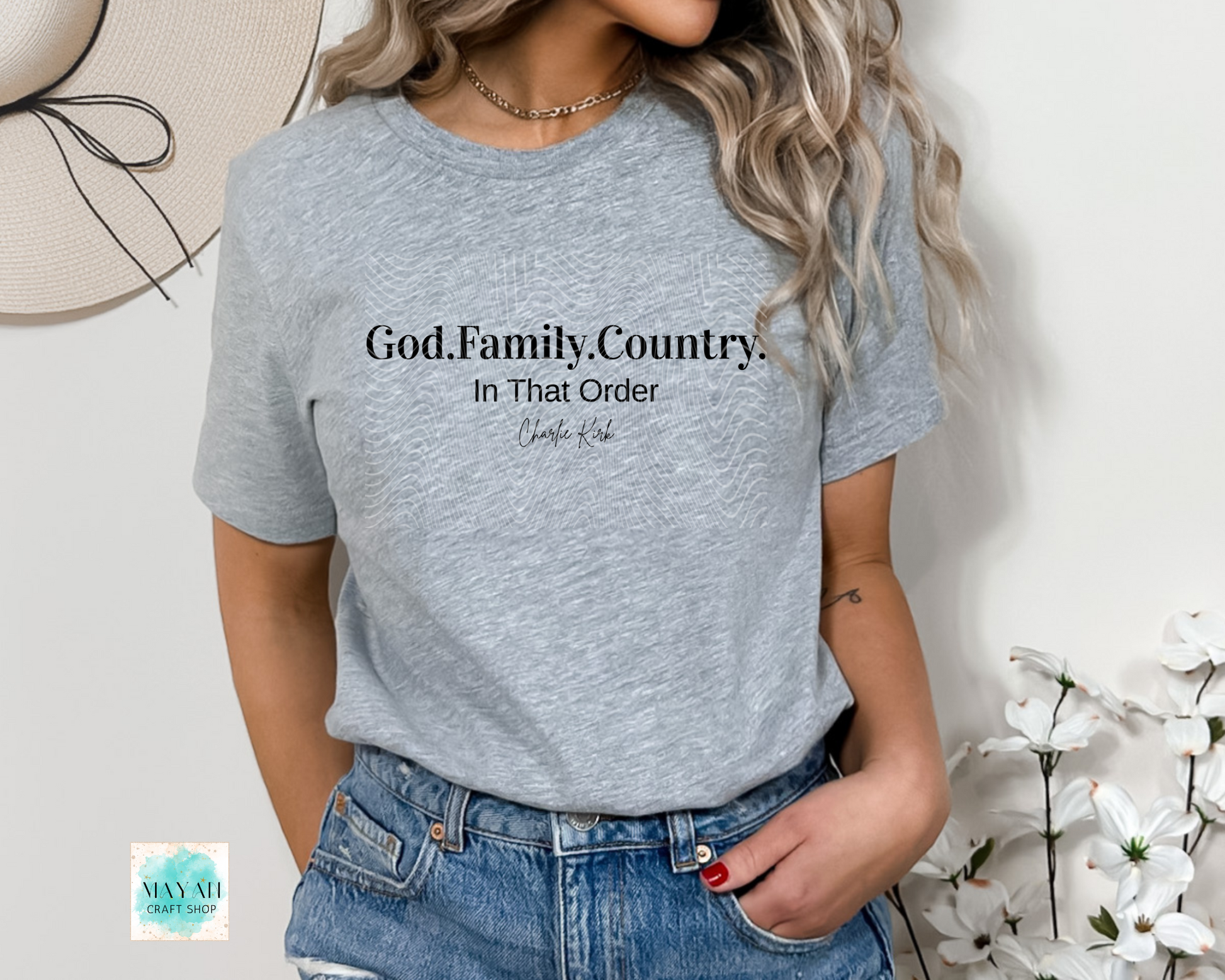 Person wearing a gray t-shirt with 'God. Family.