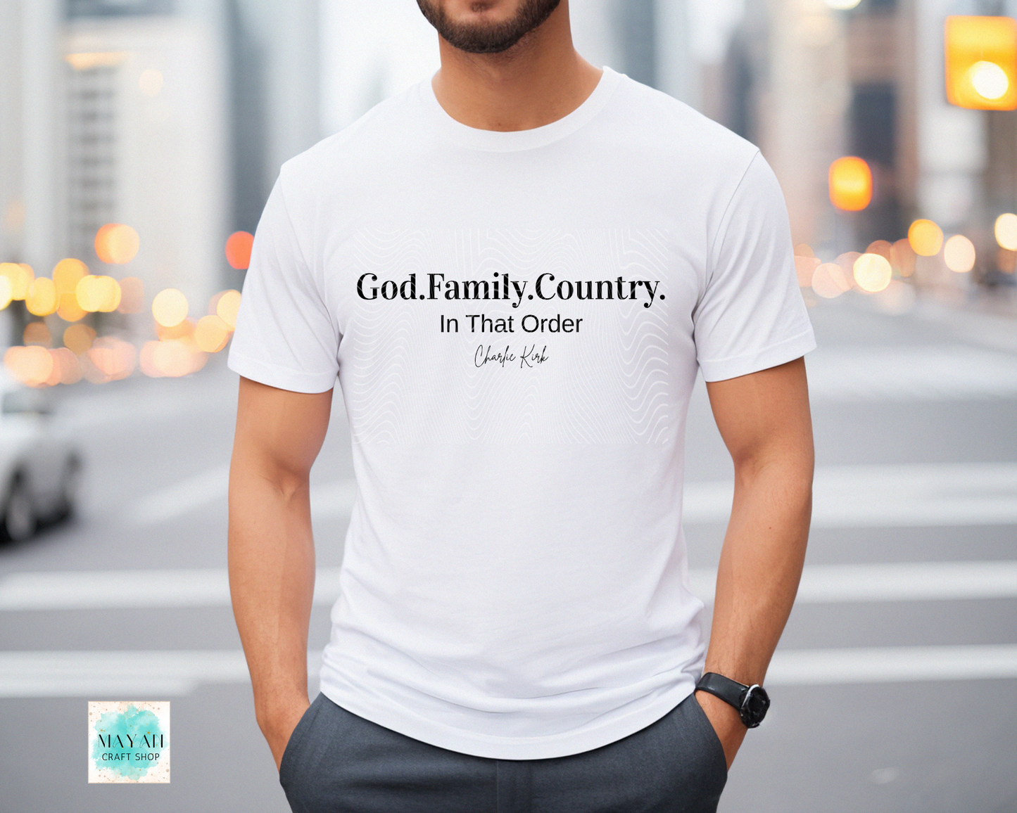 Person wearing a white t-shirt with text in an urban setting