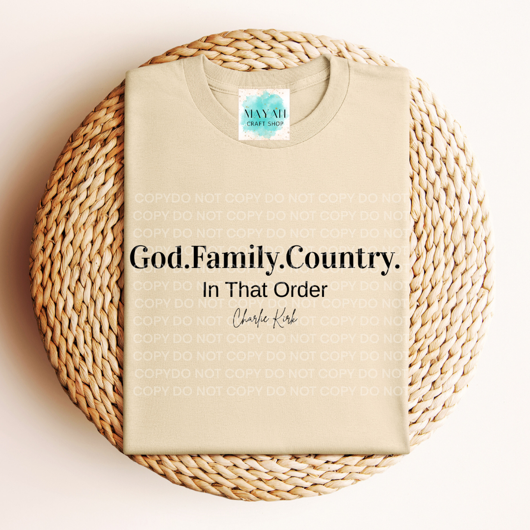 Beige t-shirt with 'God. Family. Country. In That Order' text on a woven mat