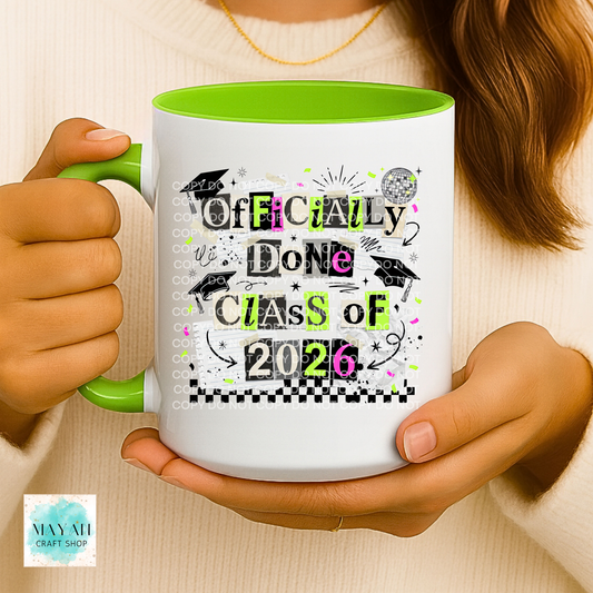 Person holding a mug with 'Class of 2026' design, featuring green and white colors.