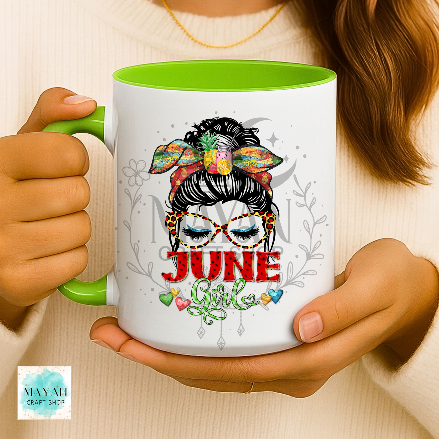 Person holding a mug with 'June Girl' design and green interior.