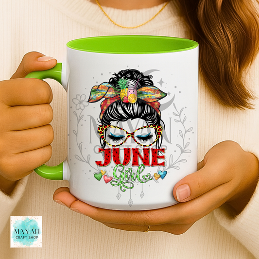 Person holding a mug with 'June Girl' design and green interior.