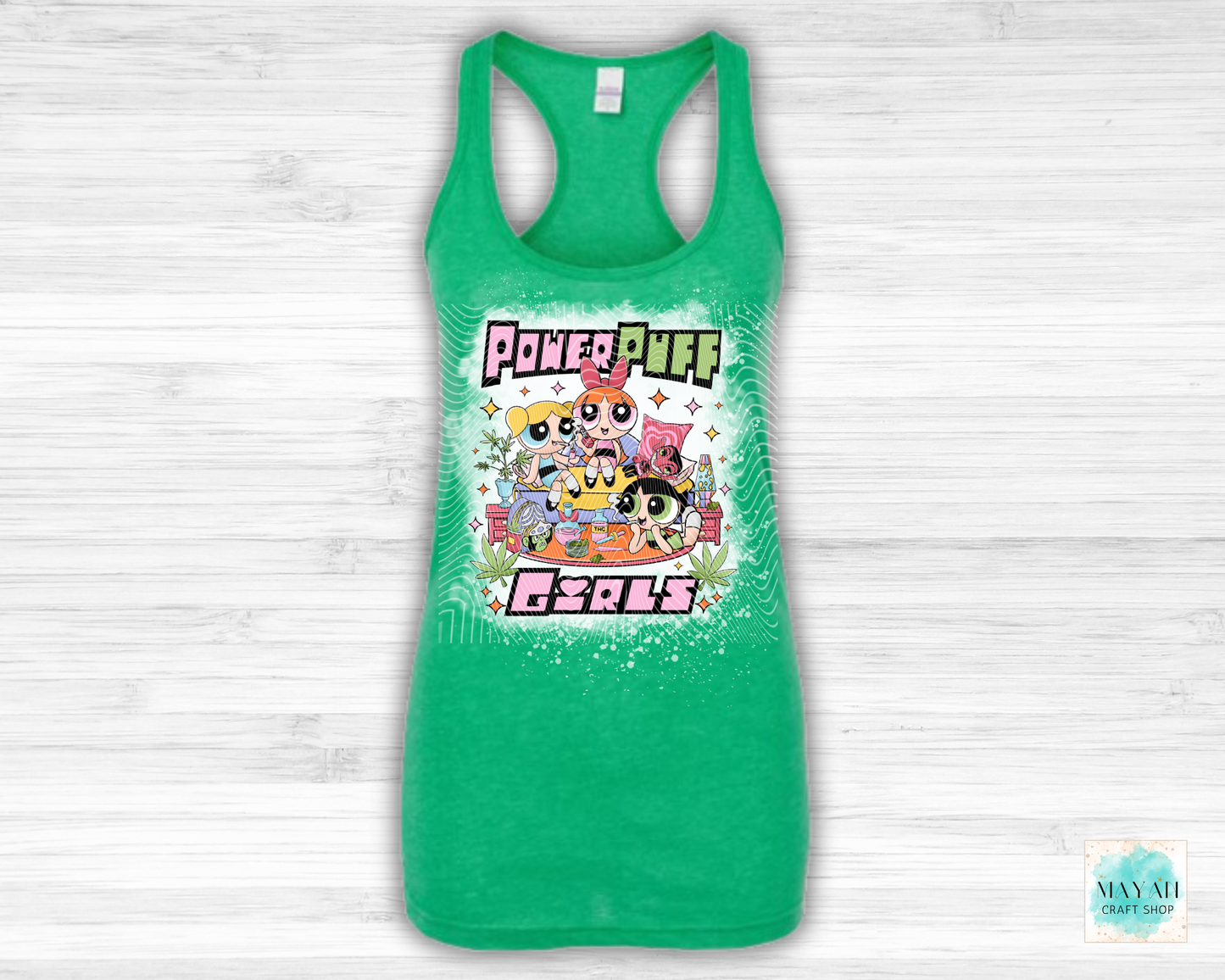 Green tank top with vibrant graphic on a white wooden background
