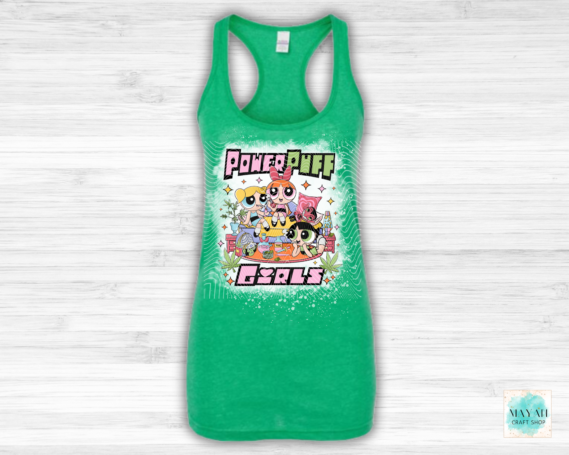 Green tank top with vibrant graphic on a white wooden background