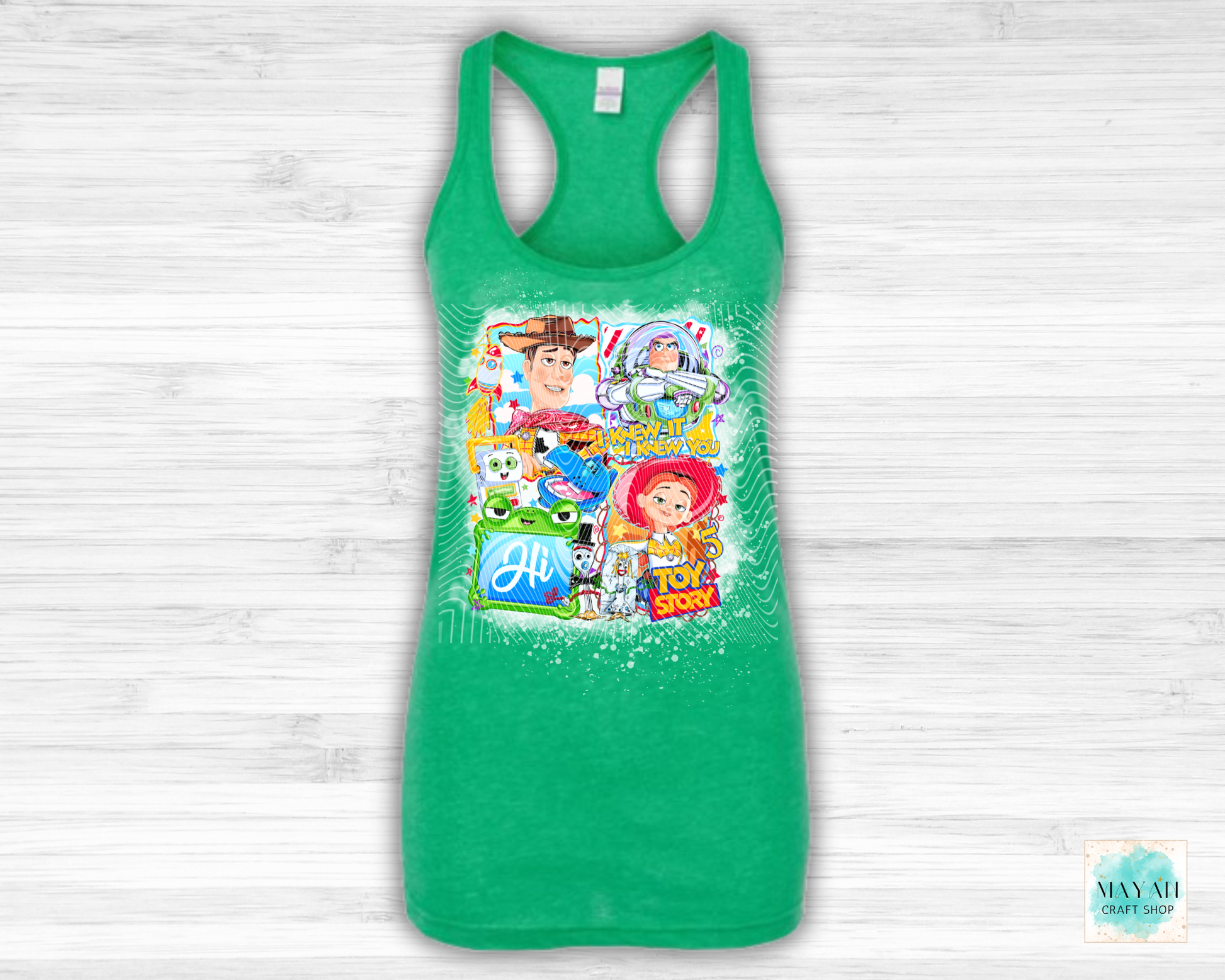 Green tank top with character collage on a white wooden background