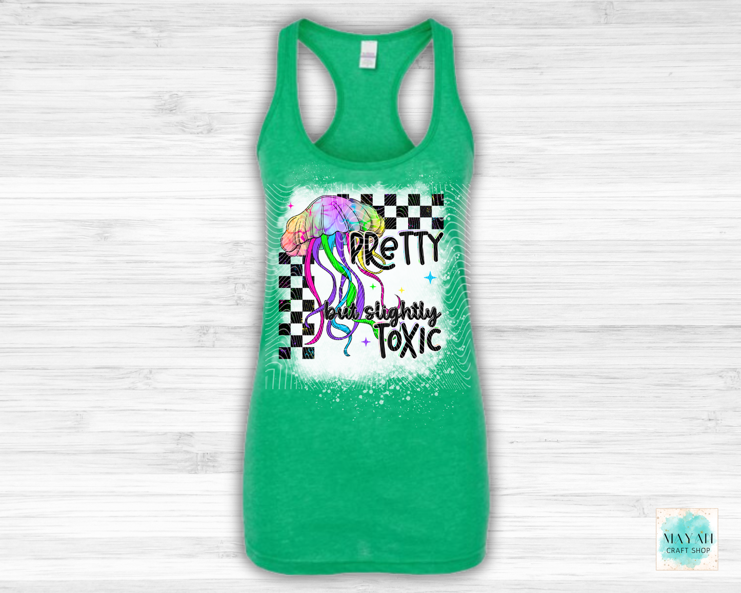 Green tank top with colorful graphic and text on a white wooden background