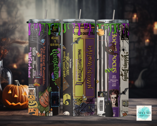 Set of Halloween-themed tumbler with decorative labels on a dark background.
