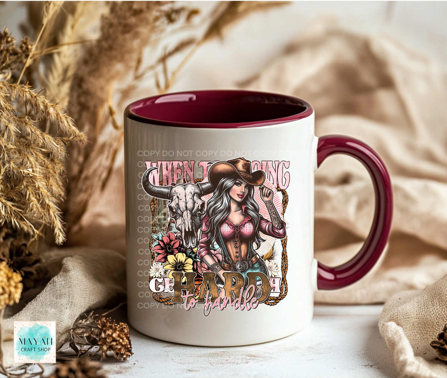 Mug with a graphic design of a woman in a cowboy hat and text, placed on a neutral background.