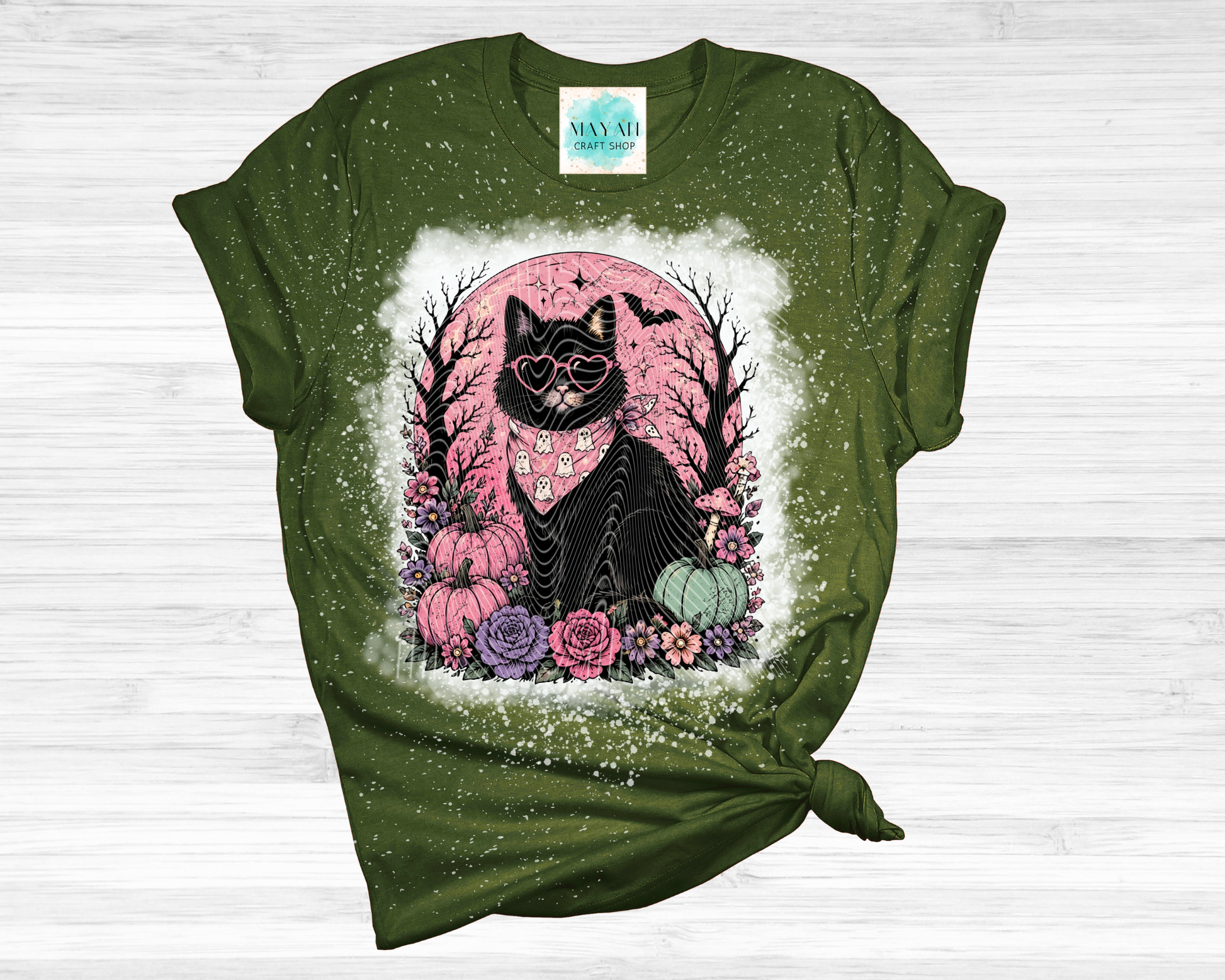 Green t-shirt with a black cat graphic on a white background