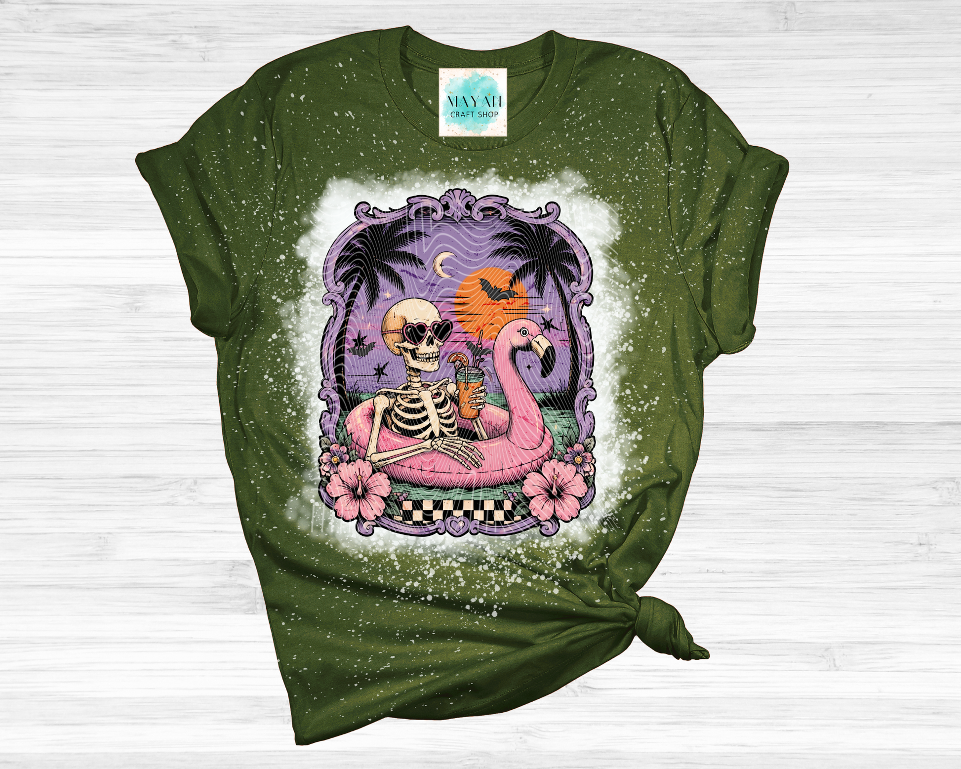 Green t-shirt with a colorful graphic of a skeleton, flamingo, and palm trees on a white background.