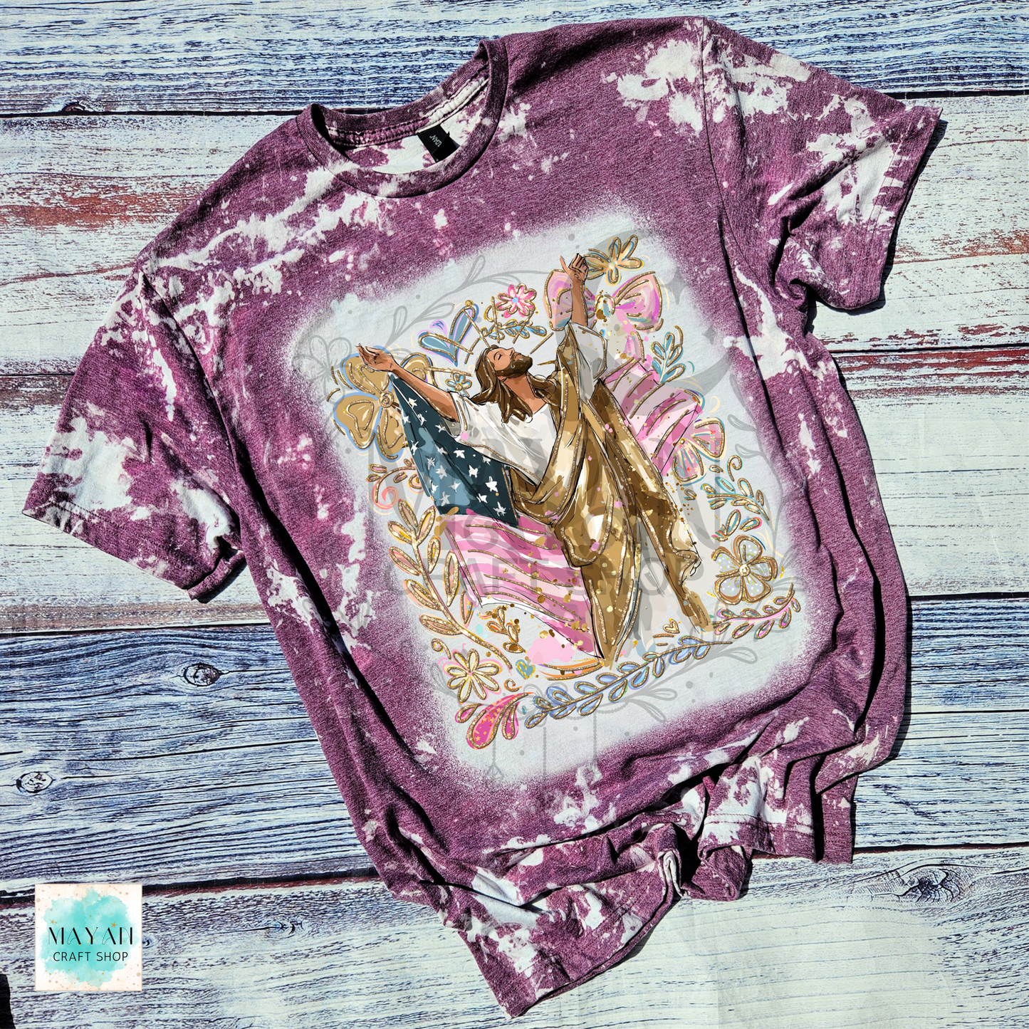 T-shirt with a graphic design of a woman holding an American flag on a wooden surface