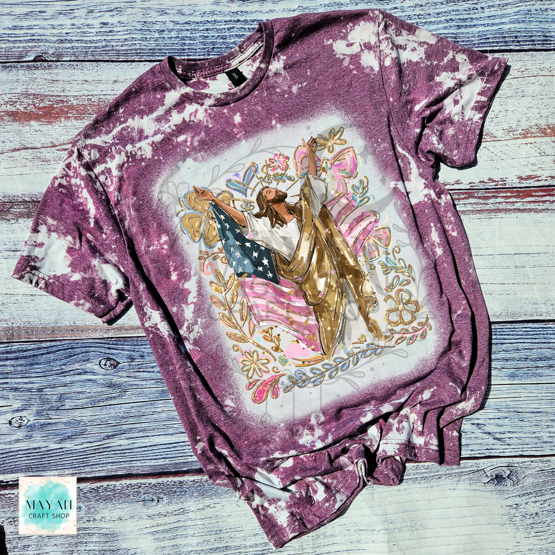 T-shirt with a graphic design of a woman holding an American flag on a wooden surface