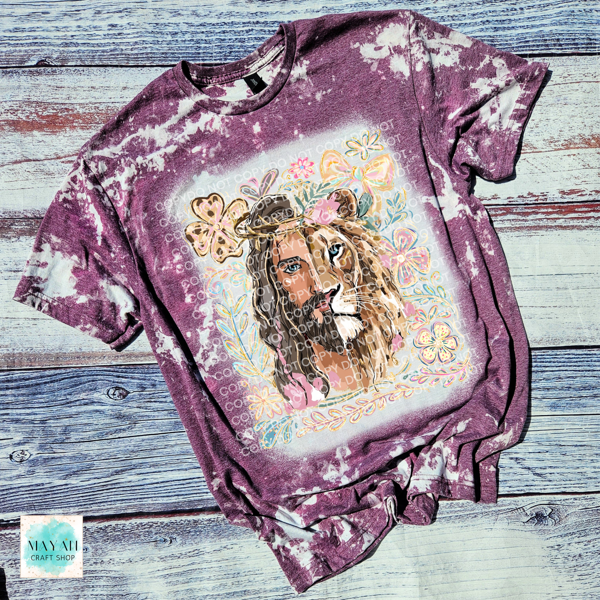 Bleached t-shirt with a lion graphic and floral elements on a wooden surface