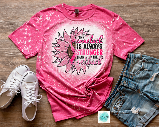 Pink t-shirt with sunflower design and motivational quote, paired with white sneakers and denim shorts on a wooden surface.
