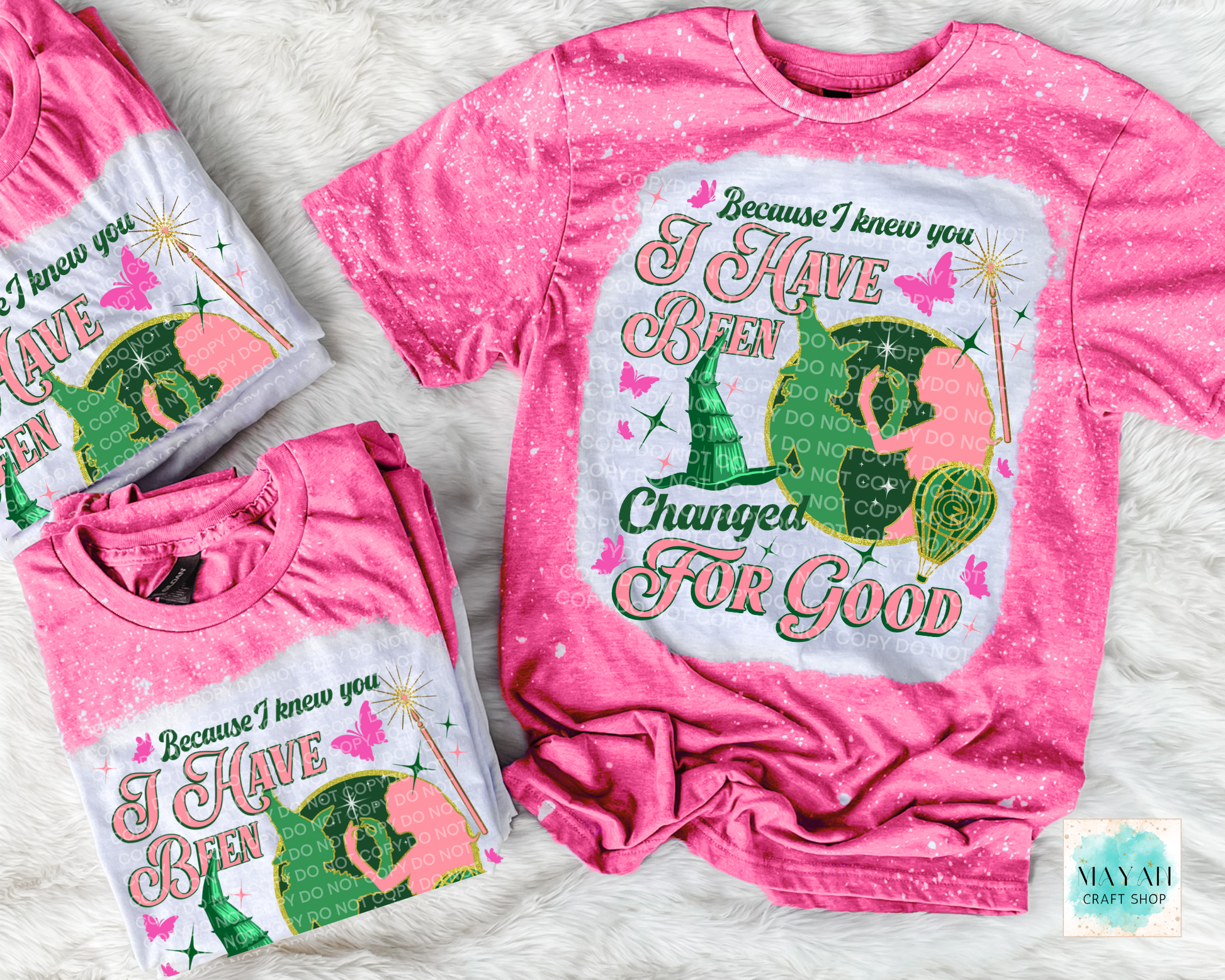 Pink t-shirt with graphic design and text on a light gray background