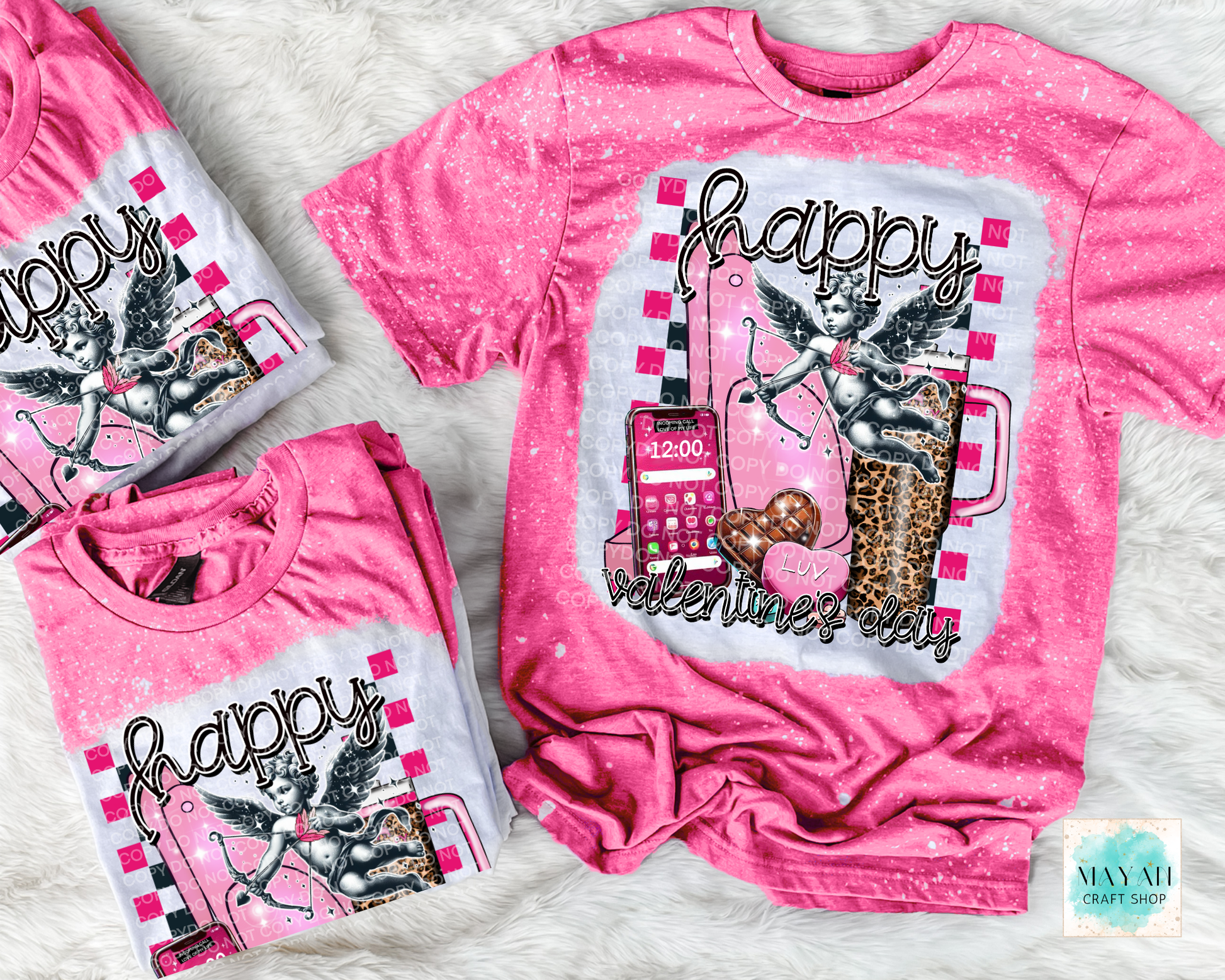 Pink t-shirt with graphic design and text on a textured surface