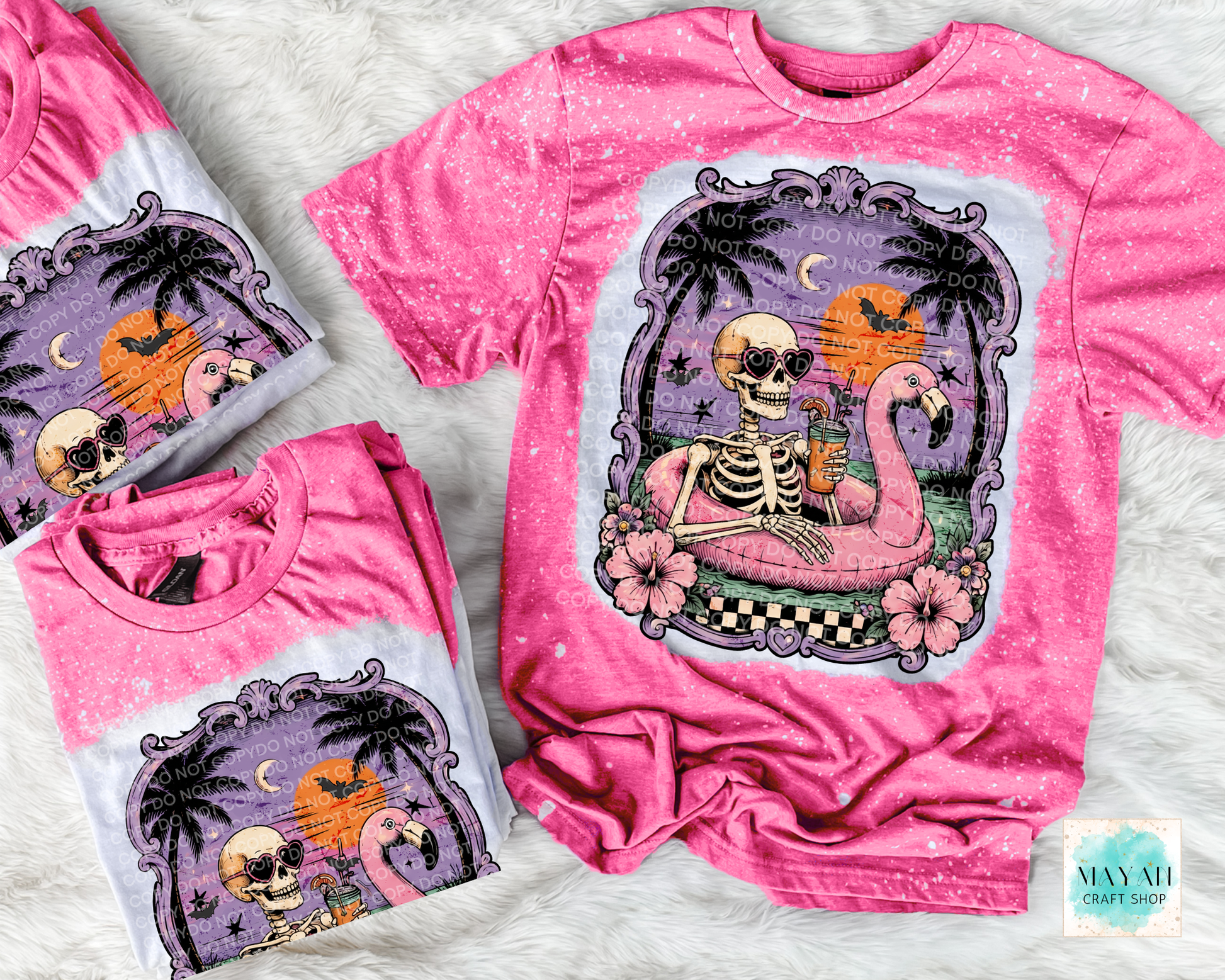 Pink t-shirt with skeleton and flamingo design on a textured surface
