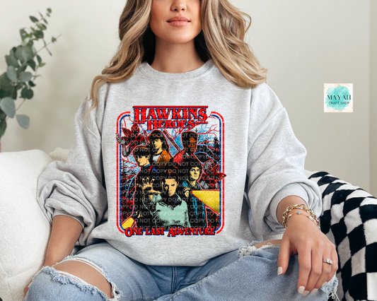 Person wearing a sweatshirt with a 'Heroes' graphic design.
