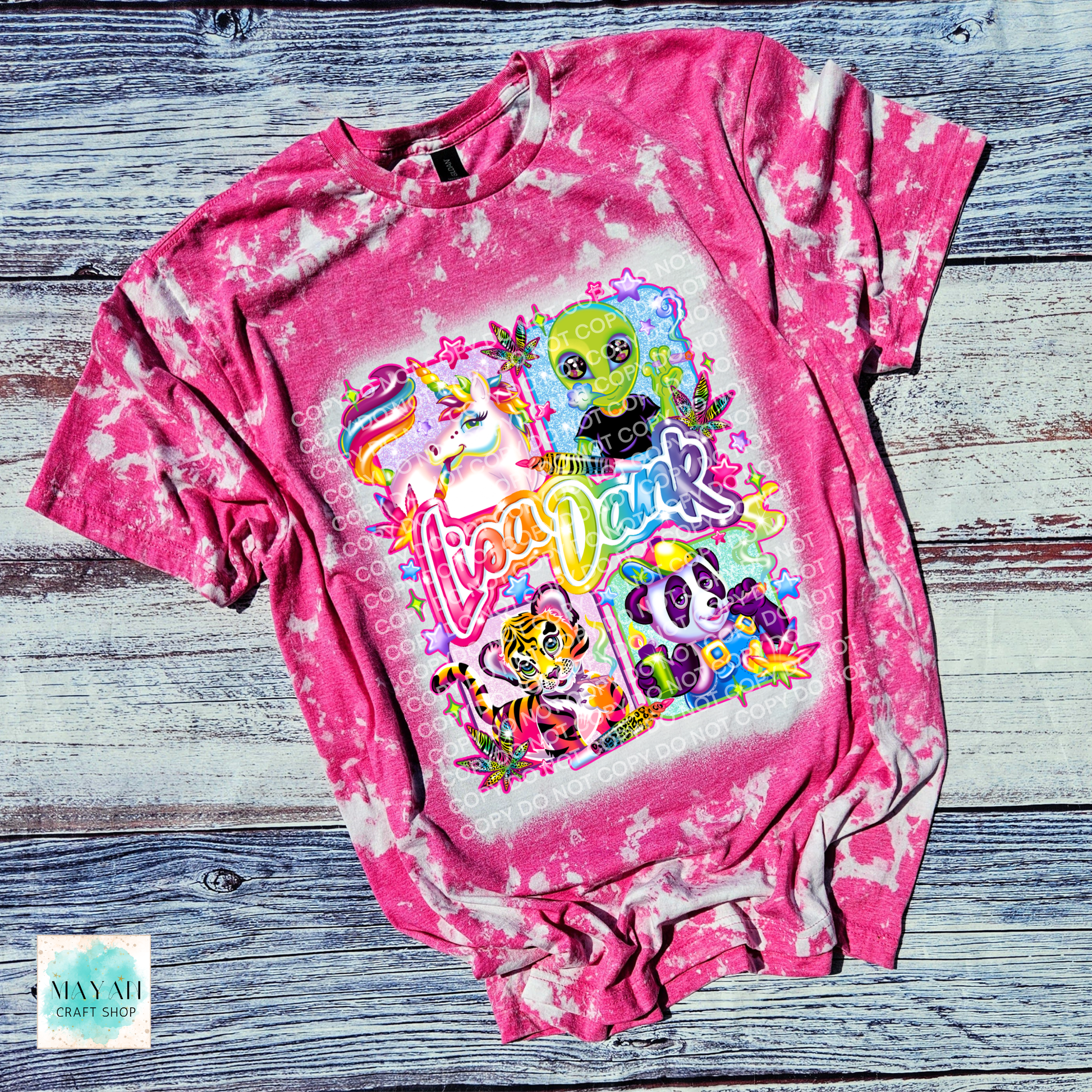 Pink tie-dye t-shirt with colorful graphic design on a wooden surface