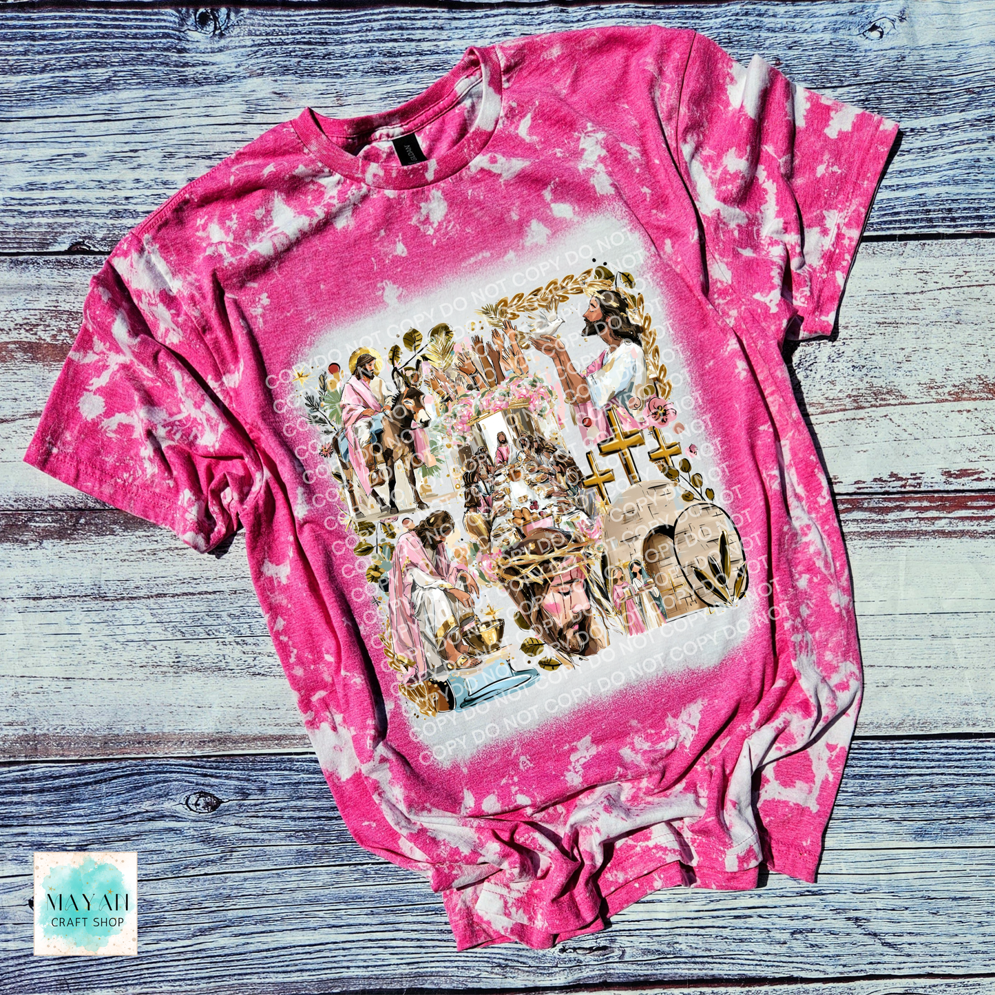 Pink tie-dye t-shirt with a graphic design on a wooden surface