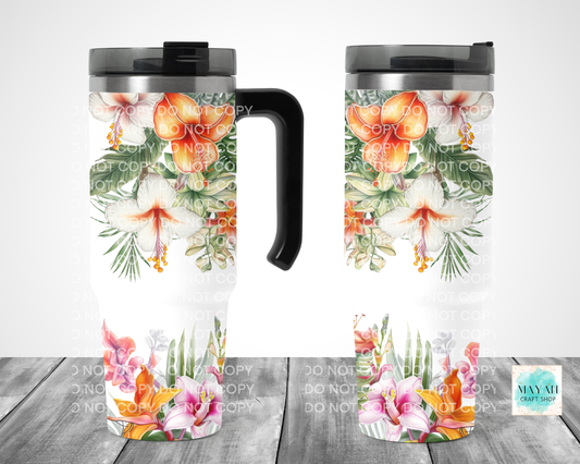 Two floral travel mugs on a wooden surface with a white background