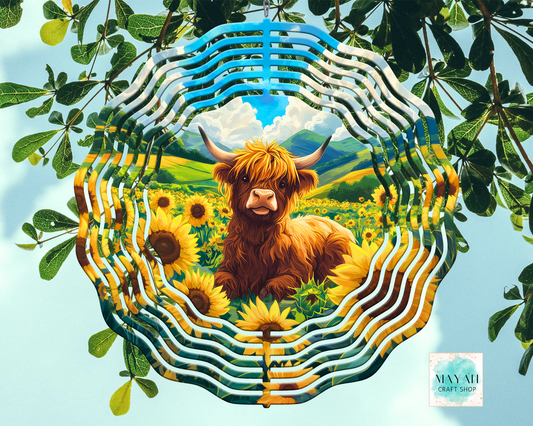 Artistic depiction of a Highland cow surrounded by sunflowers and greenery, framed by decorative elements.