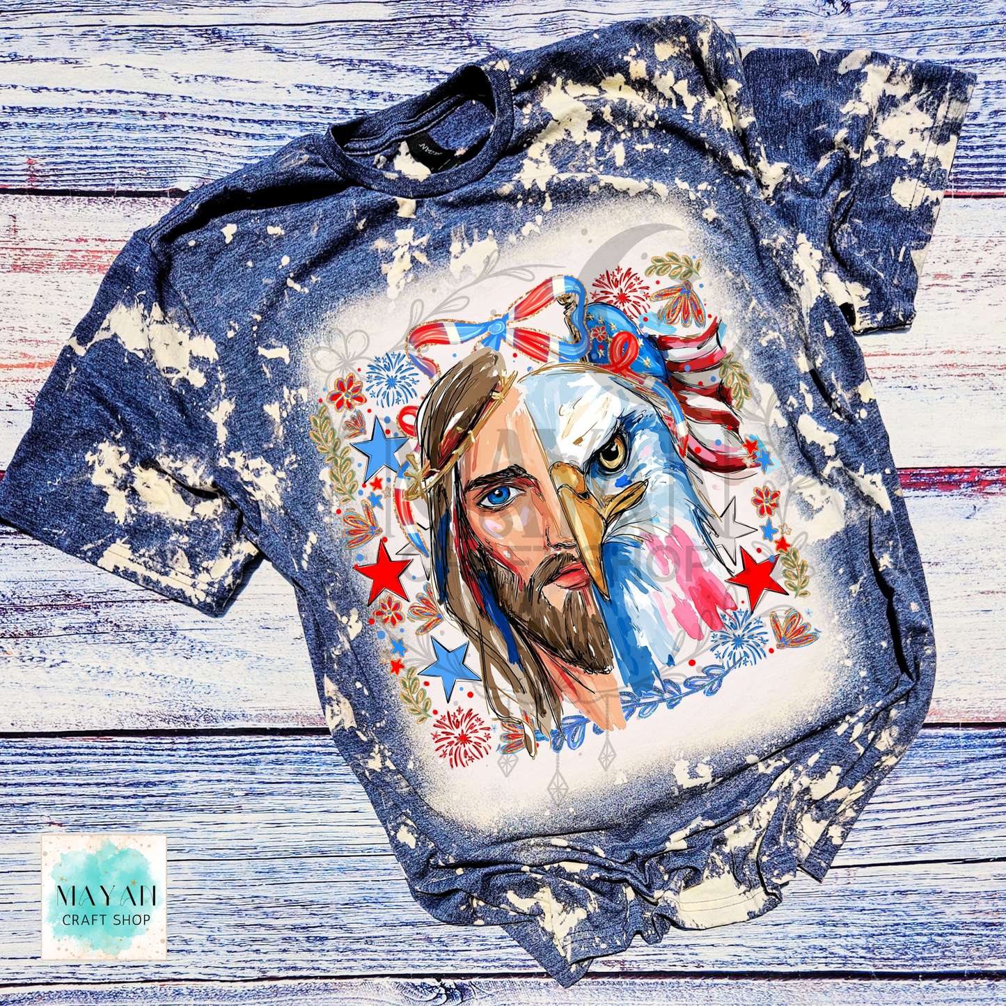T-shirt with a graphic design of a face with an eagle head and American flag elements on a wooden surface.