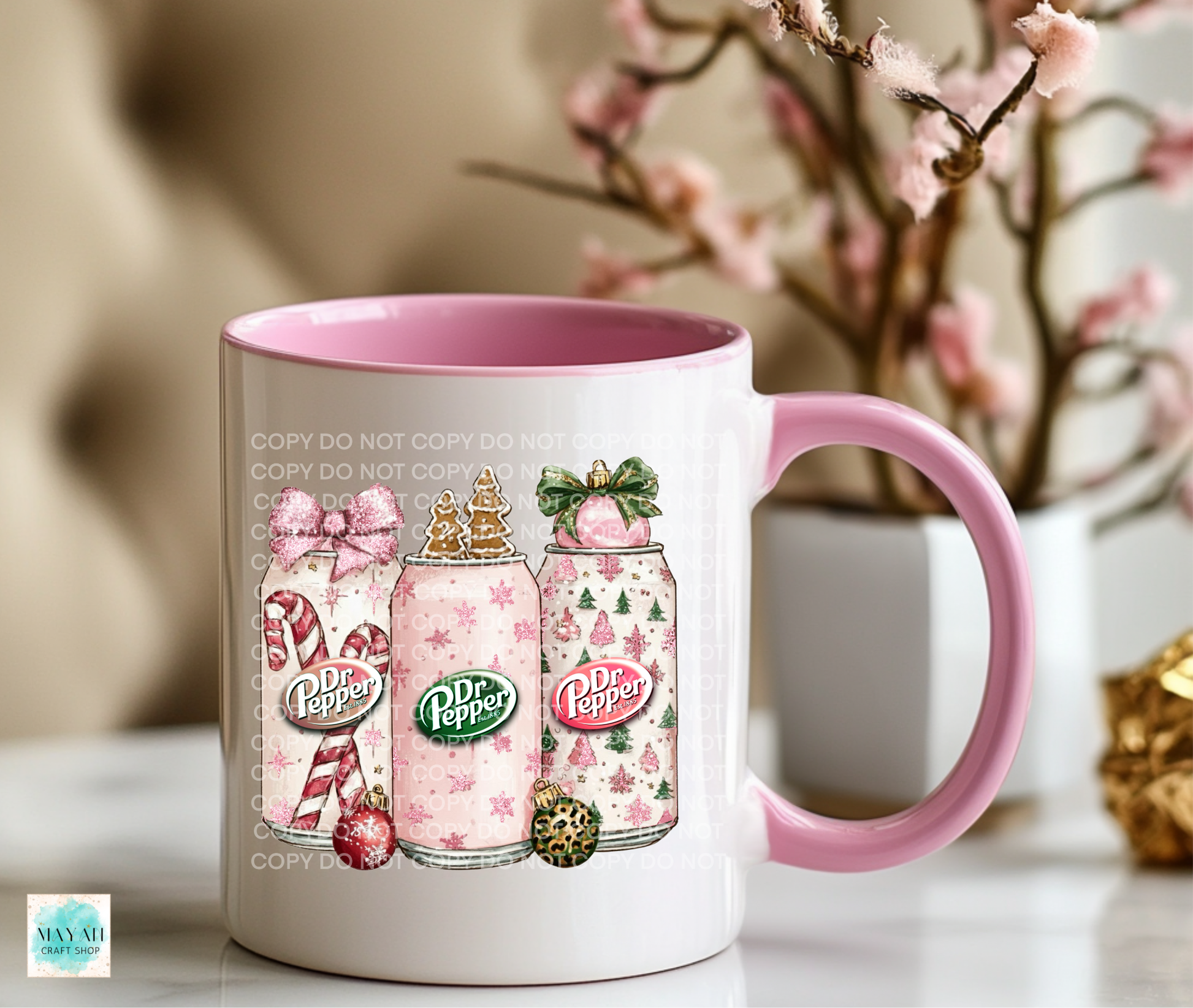 White mug with pink interior and handle featuring soft drinks graphics on a blurred background