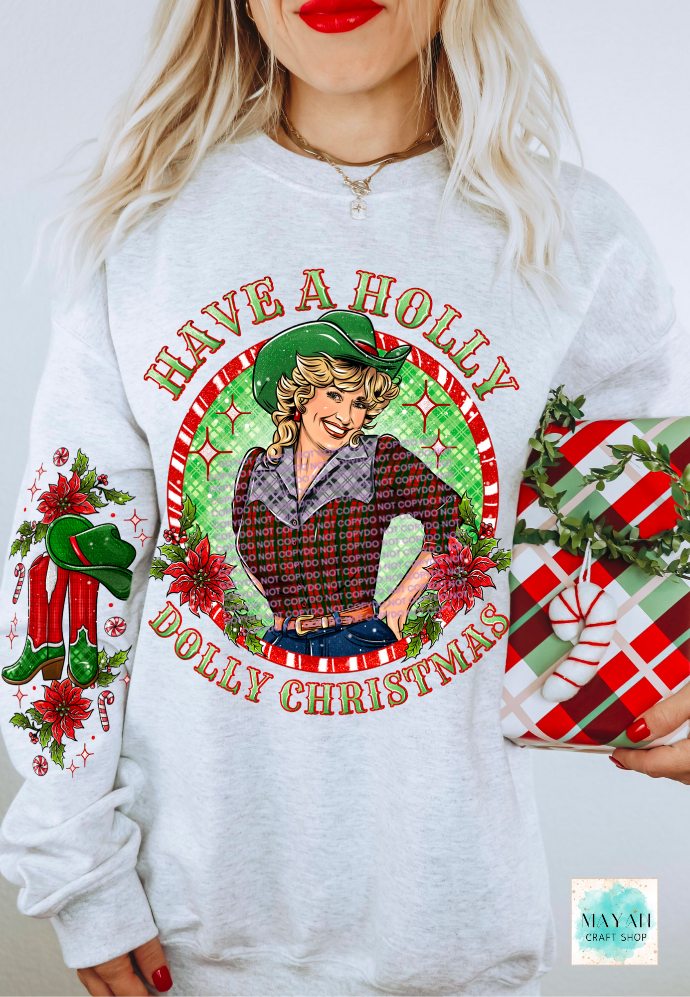 White sweatshirt with Christmas-themed design featuring a graphic of a woman and text 'Have a Holly Dolly Christmas'.