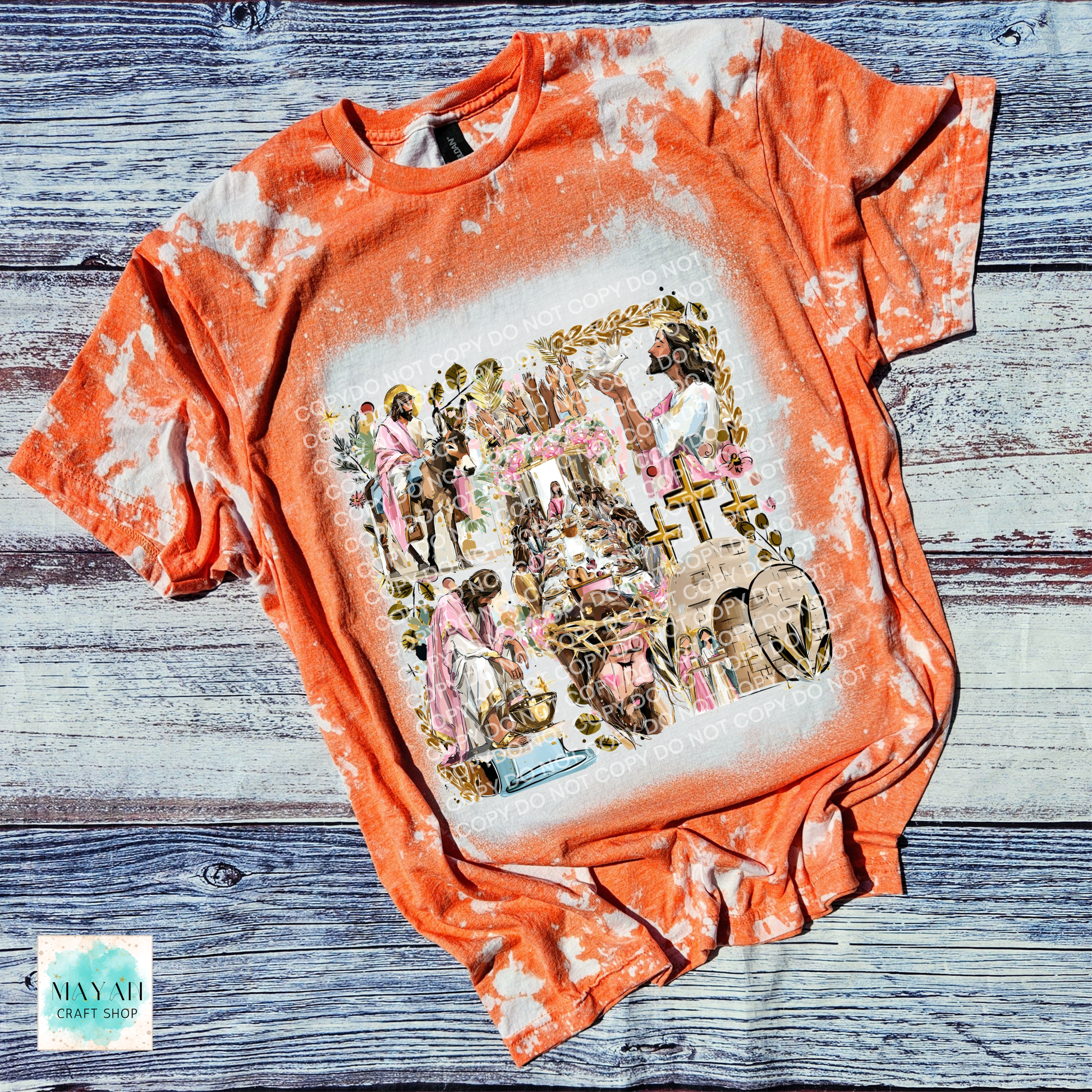 Orange tie-dye t-shirt with graphic design on a wooden surface