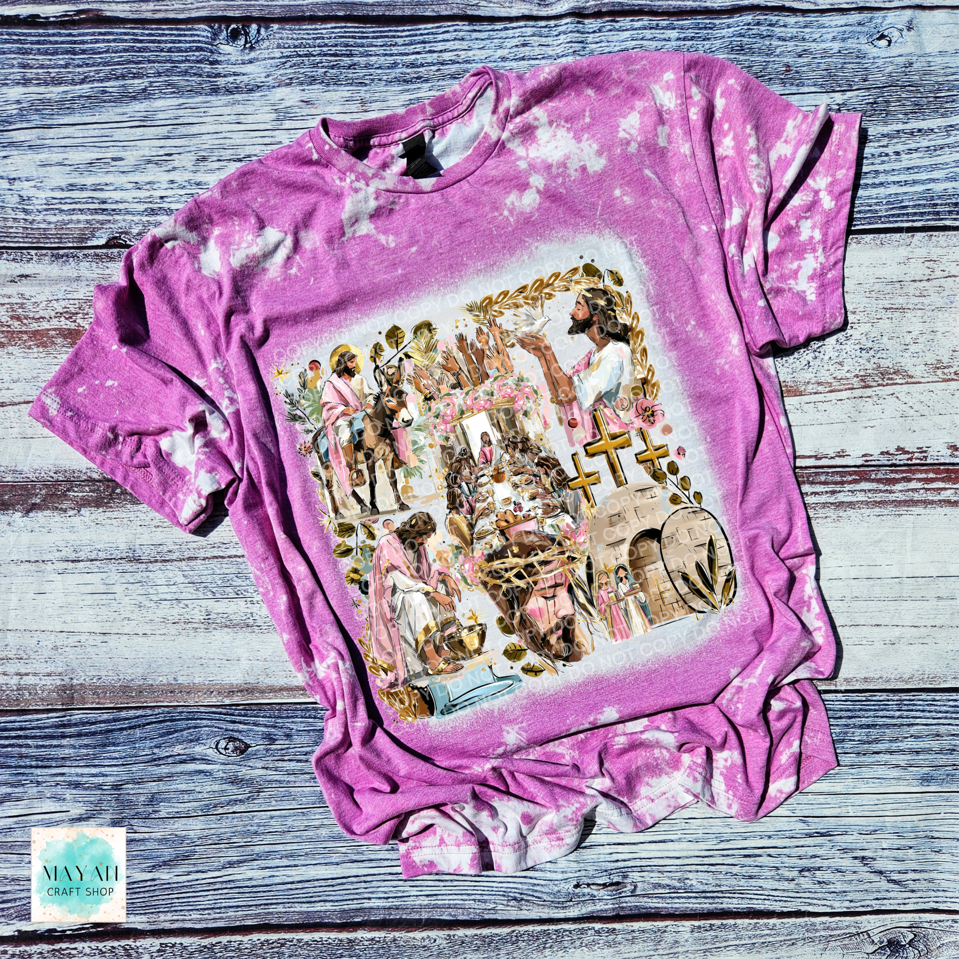 Pink tie-dye t-shirt with a graphic design on a wooden surface