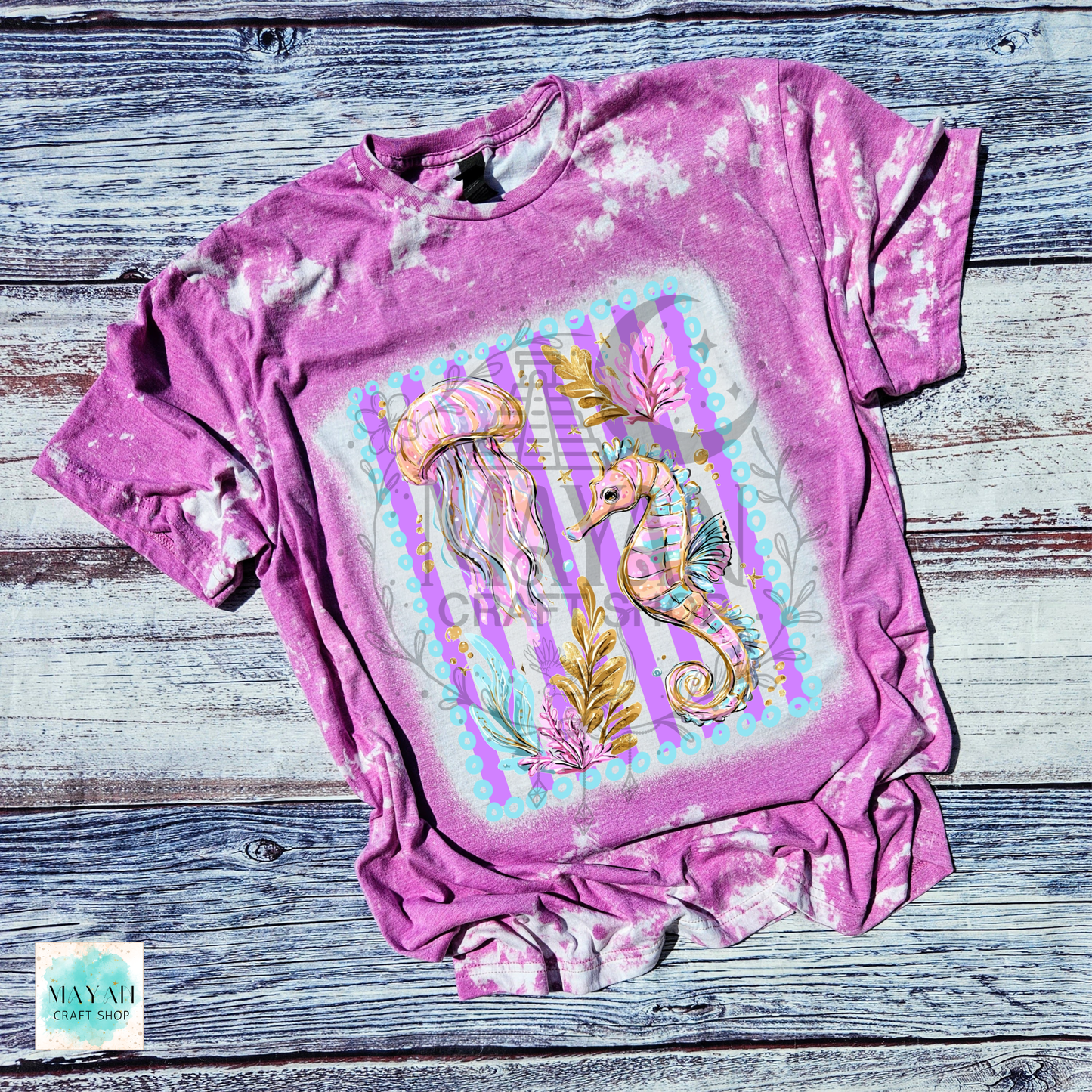 Orchid t-shirt with seahorse and jellyfish design on a wooden surface