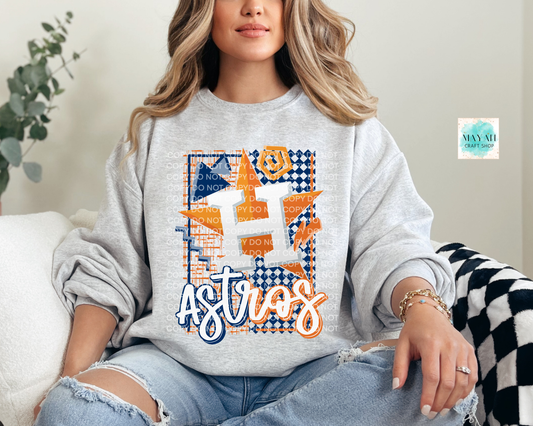 Person wearing a gray sweatshirt with a baseball design, sitting on a couch.