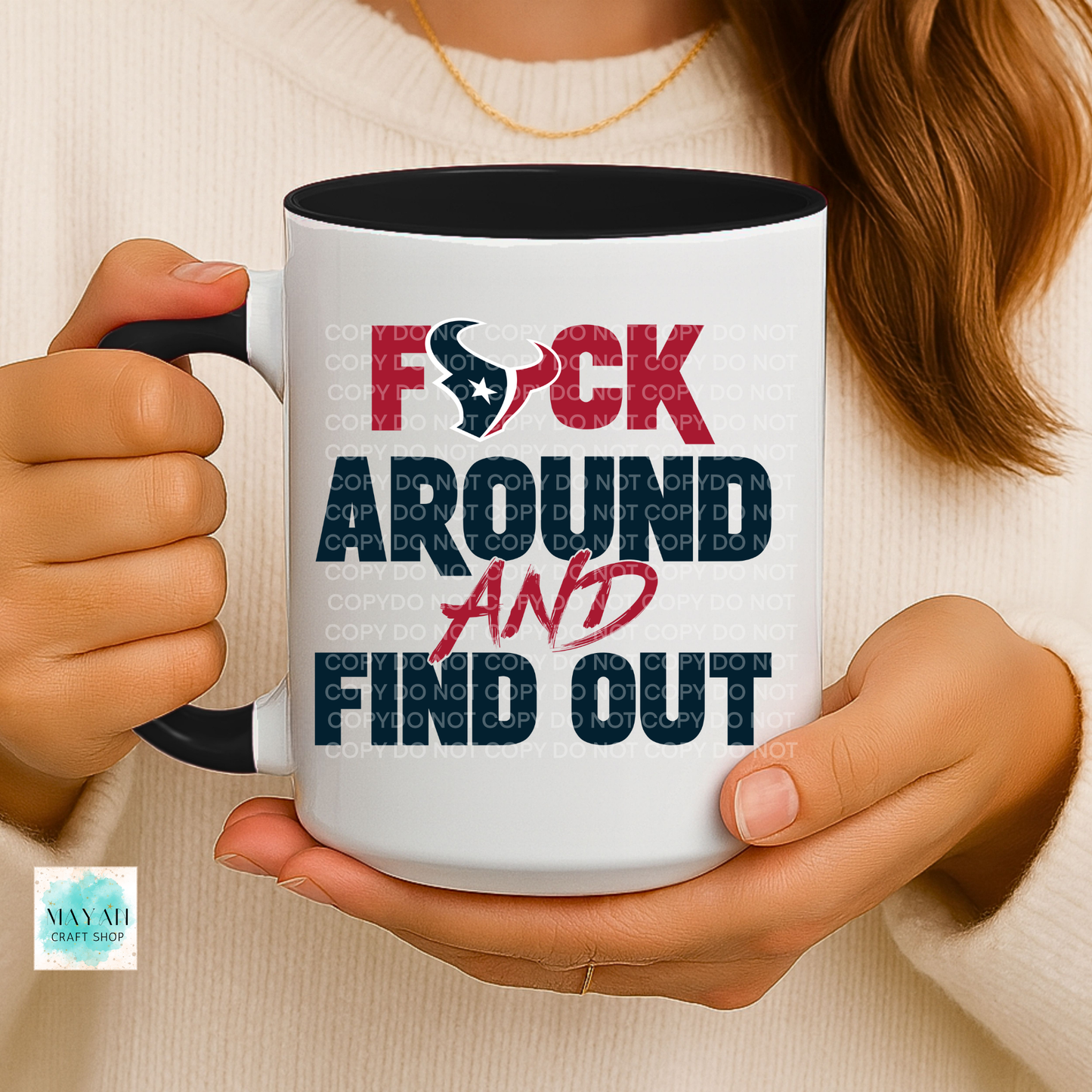 Person holding a mug with a colorful text design