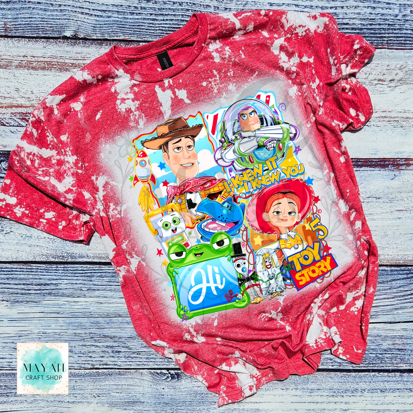 Red tie-dye t-shirt with character graphics on a wooden surface