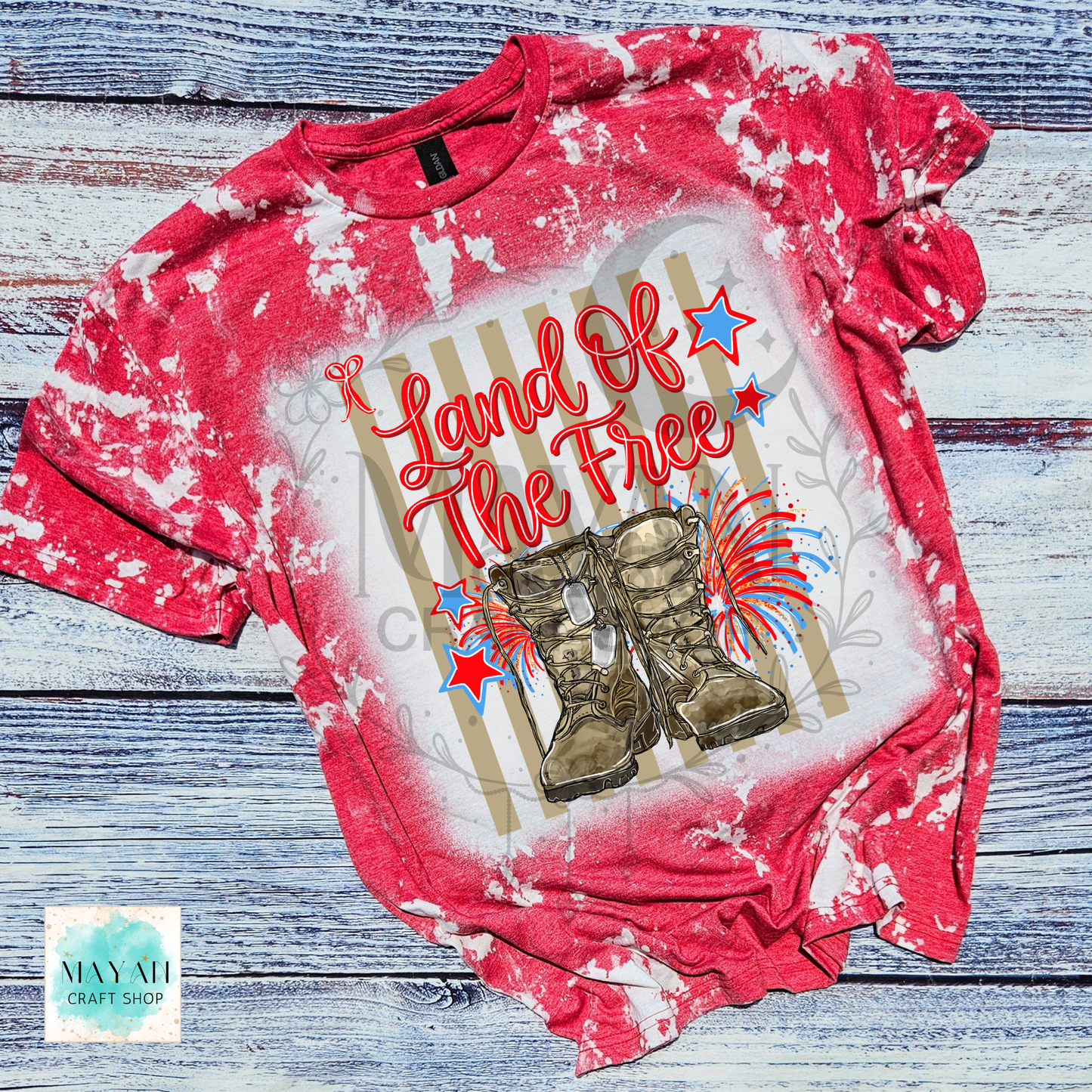 Red bleached t-shirt with 'Land of the Free' graphic on a wooden surface