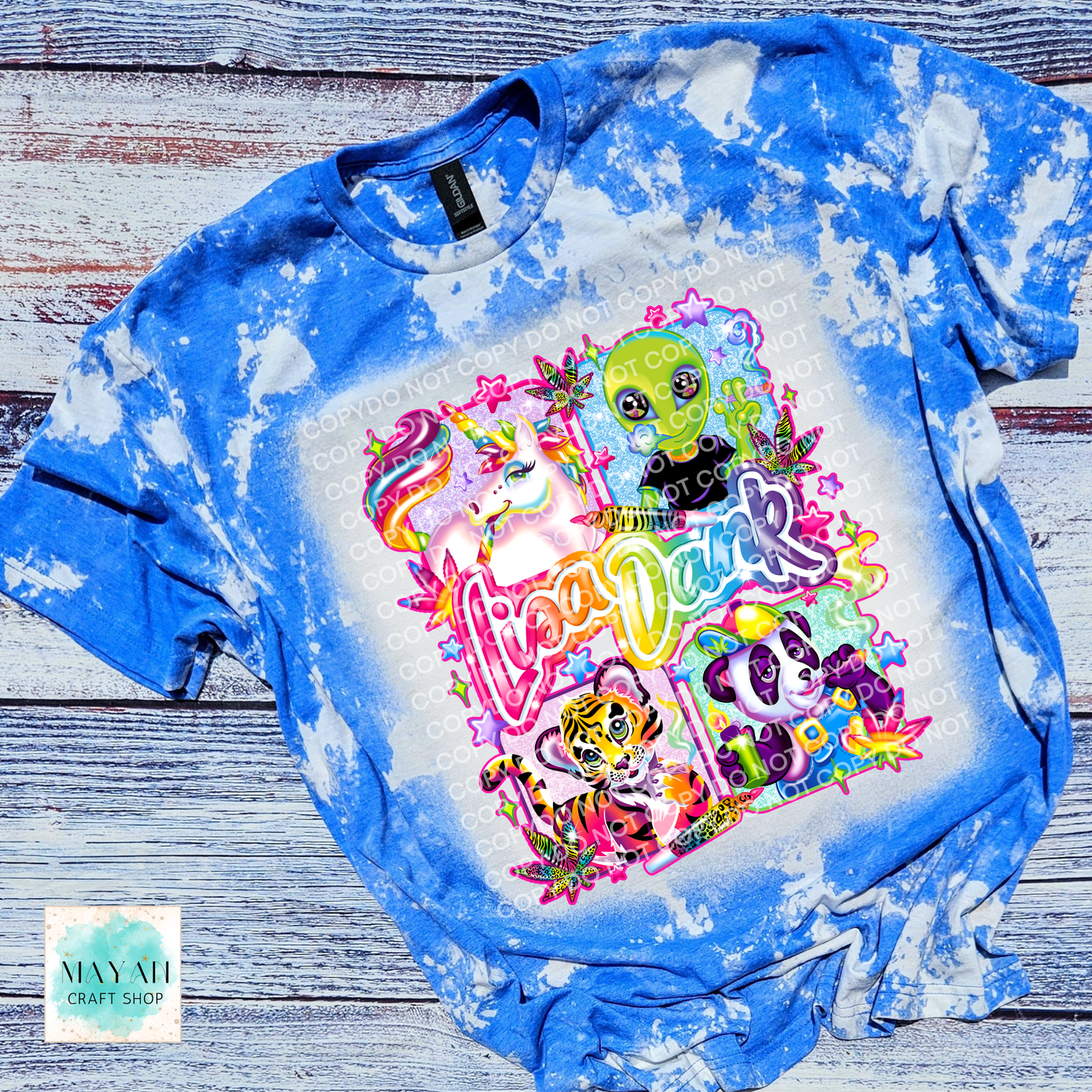 Bleached blue t-shirt with colorful graphic design on a wooden surface