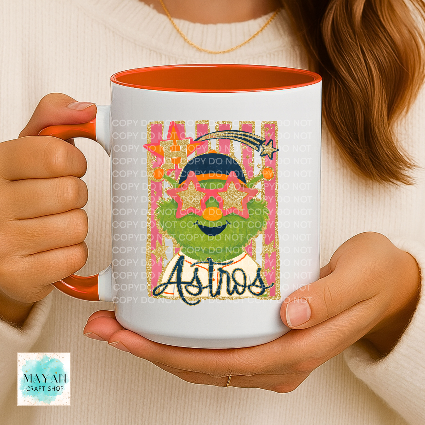 Person holding a mug with a colorful a vibrant design, brand logo visible.
