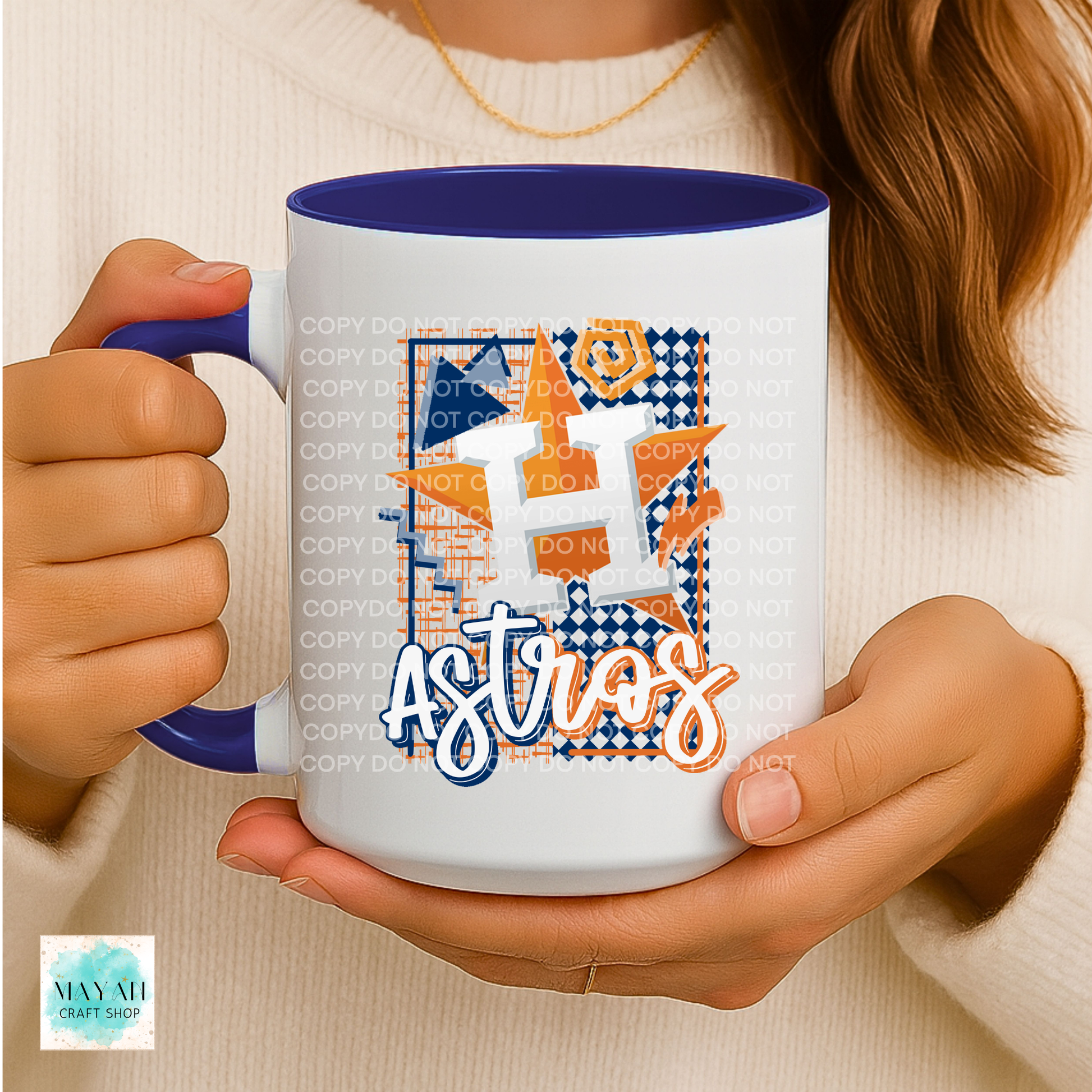 Person holding a mug with a vibrant design, featuring blue and orange colors.